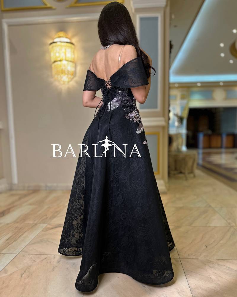 Black dress embroidered with leaf patterns