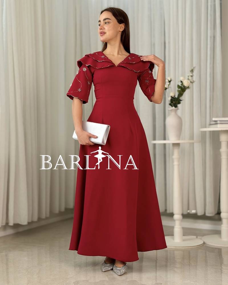 Long red dress with embroidered sleeves