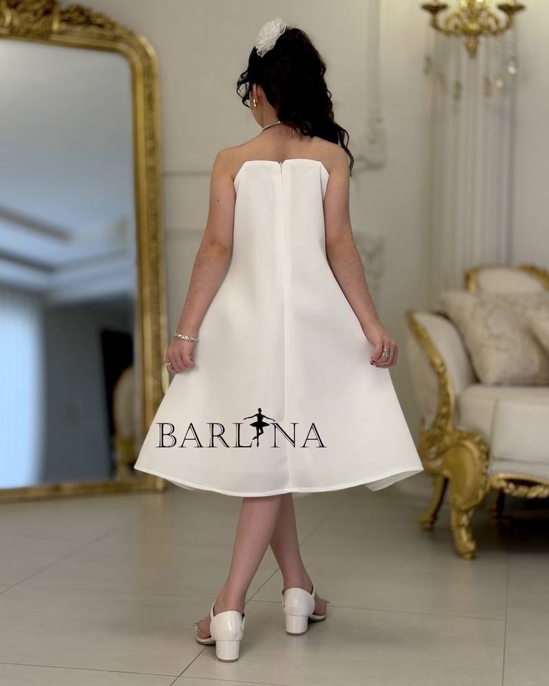 White girl's dress decorated with crystal details