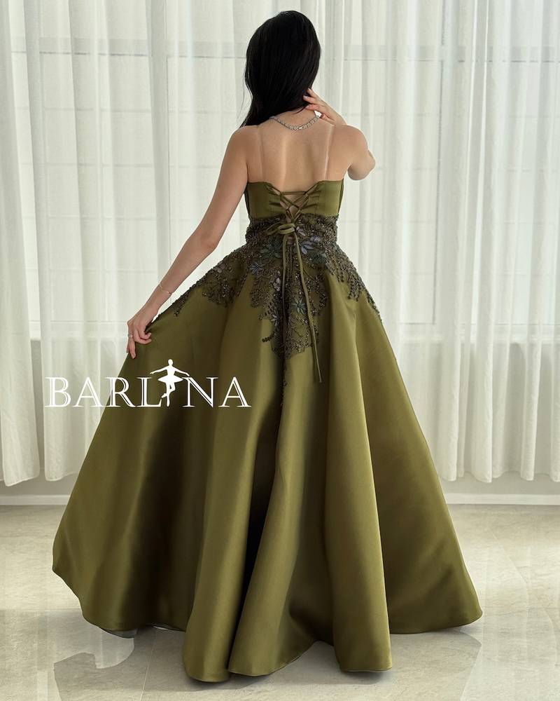 Long green evening dress with a ruffled bodice