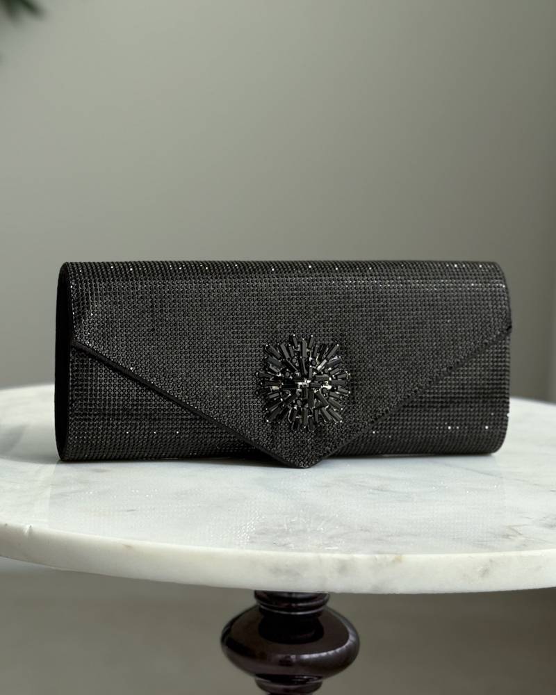 An elegant evening bag with a prominent central embellishment.