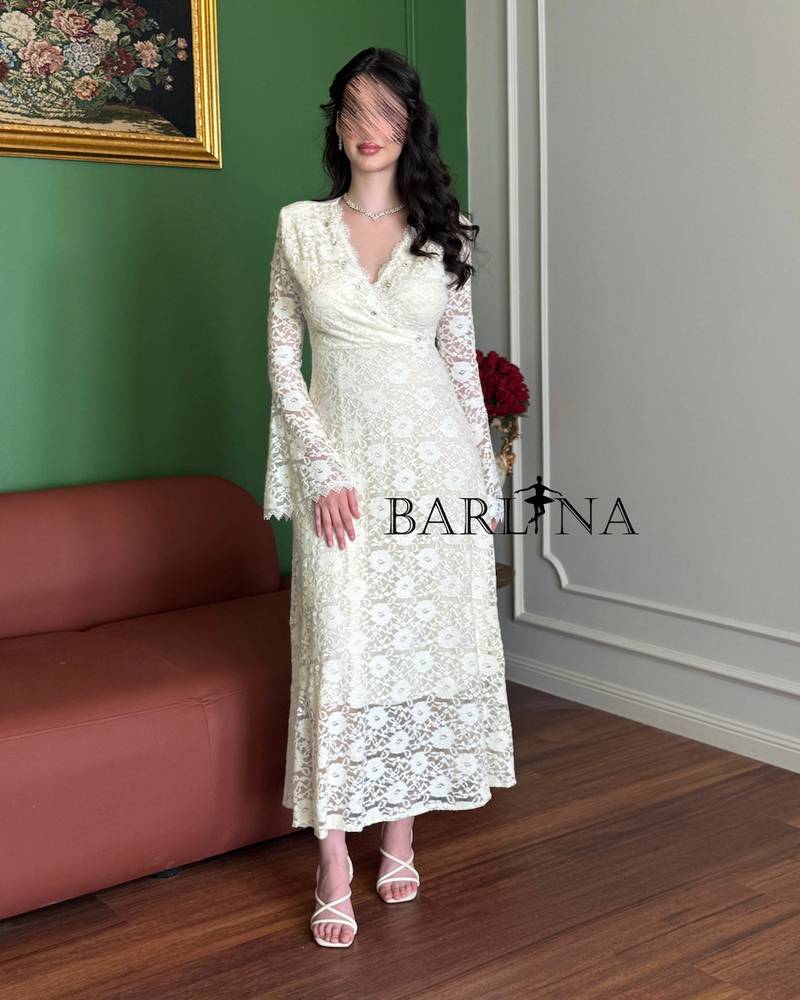 An elegant off-white dress with long sleeves