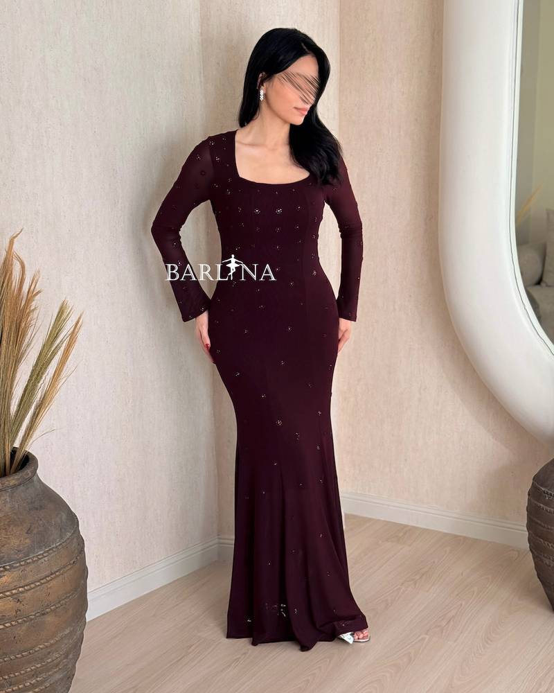 Long burgundy fitted dress with delicate embellishments