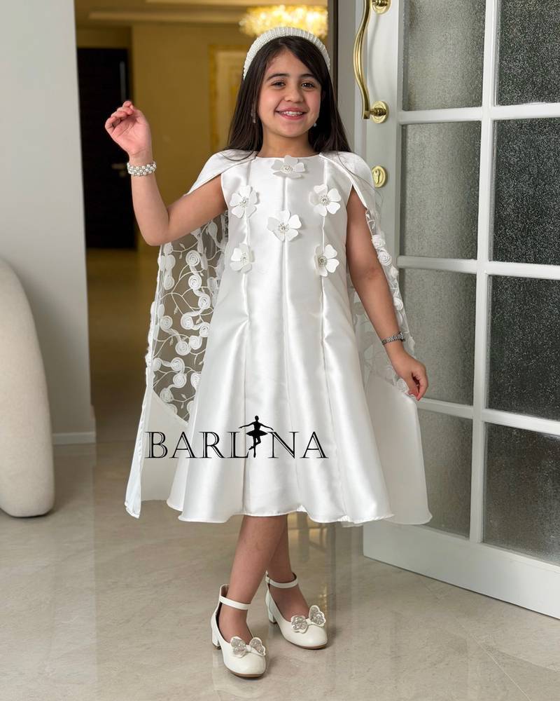 White dress with a lace cape and delicate embroidery