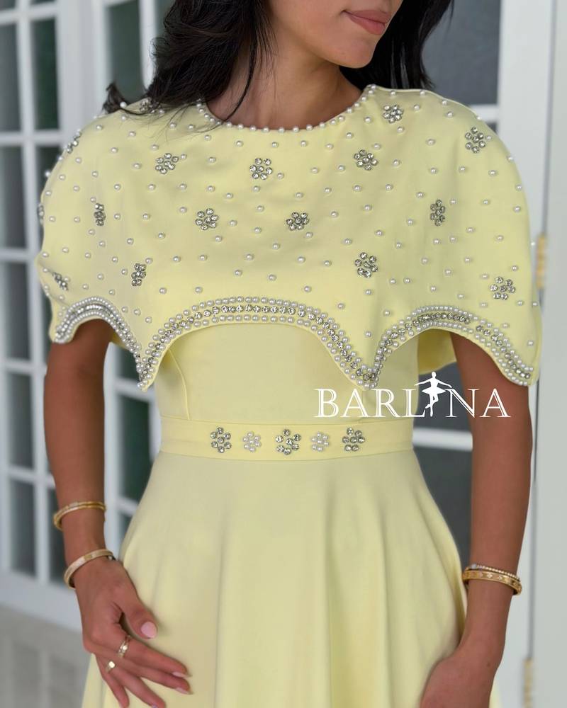 Yellow dress with an off-the-shoulder piece and a crystal belt
