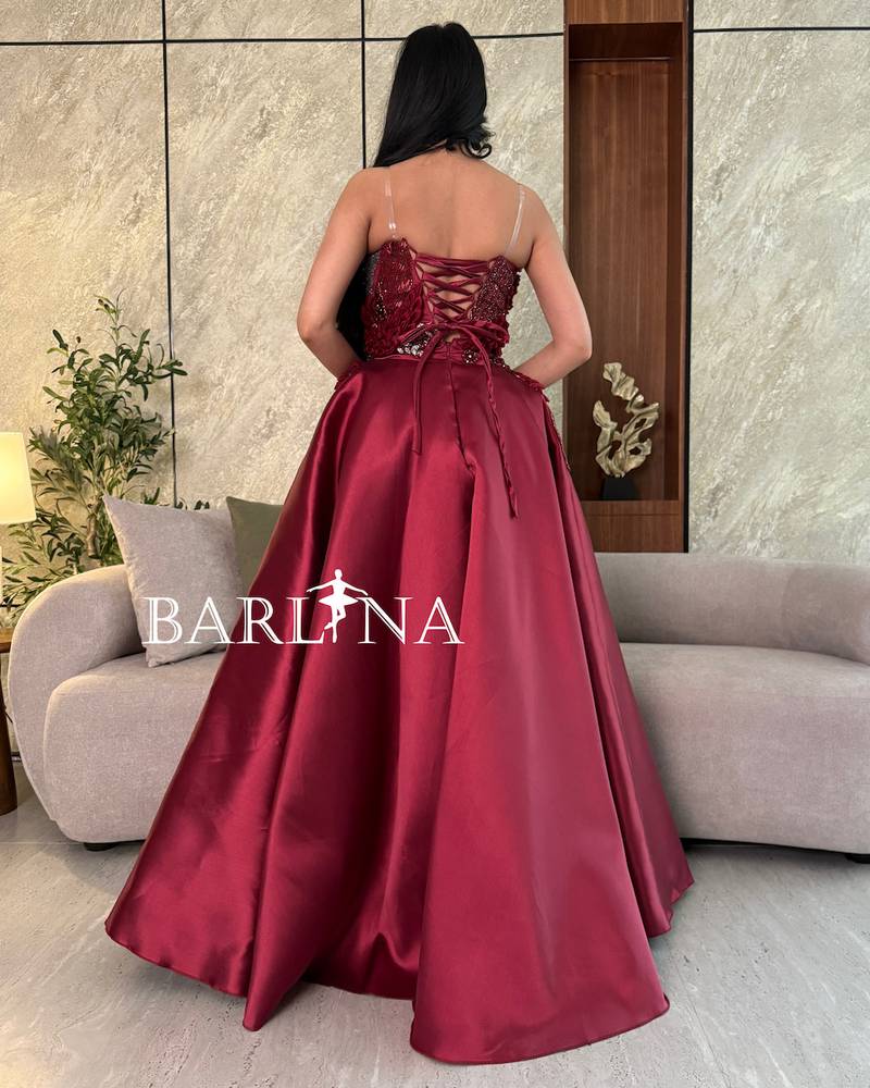 Burgundy dress with prominent beaded and sequin embroidery