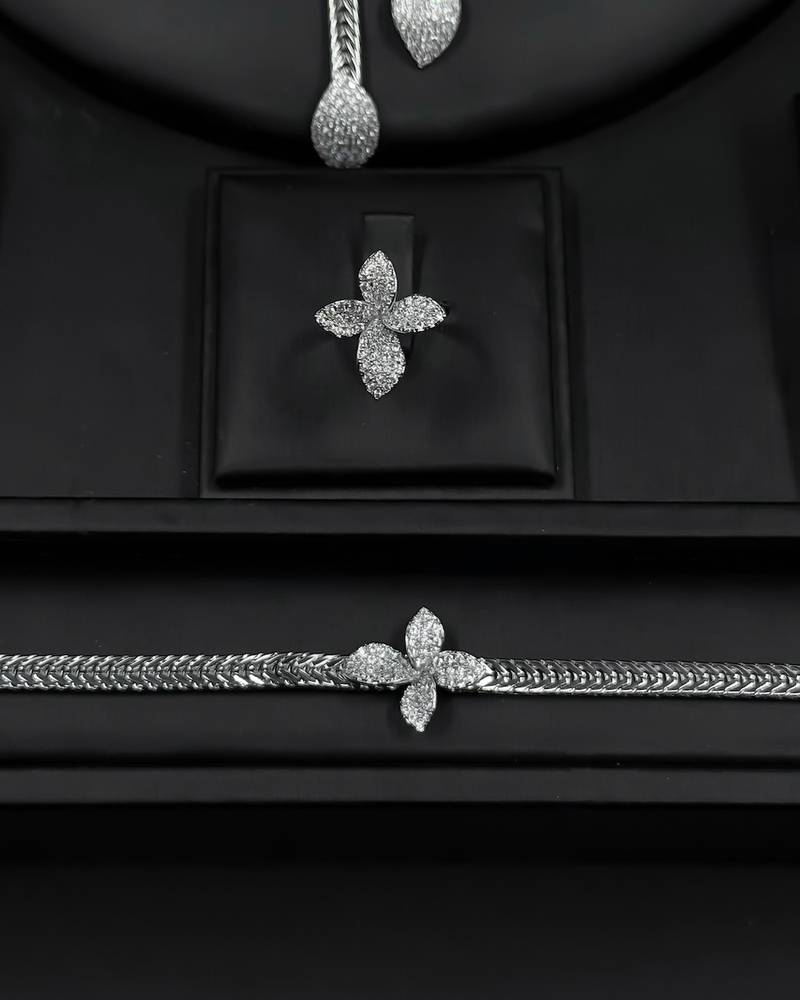 Silver accessory set with a four-petaled flower design