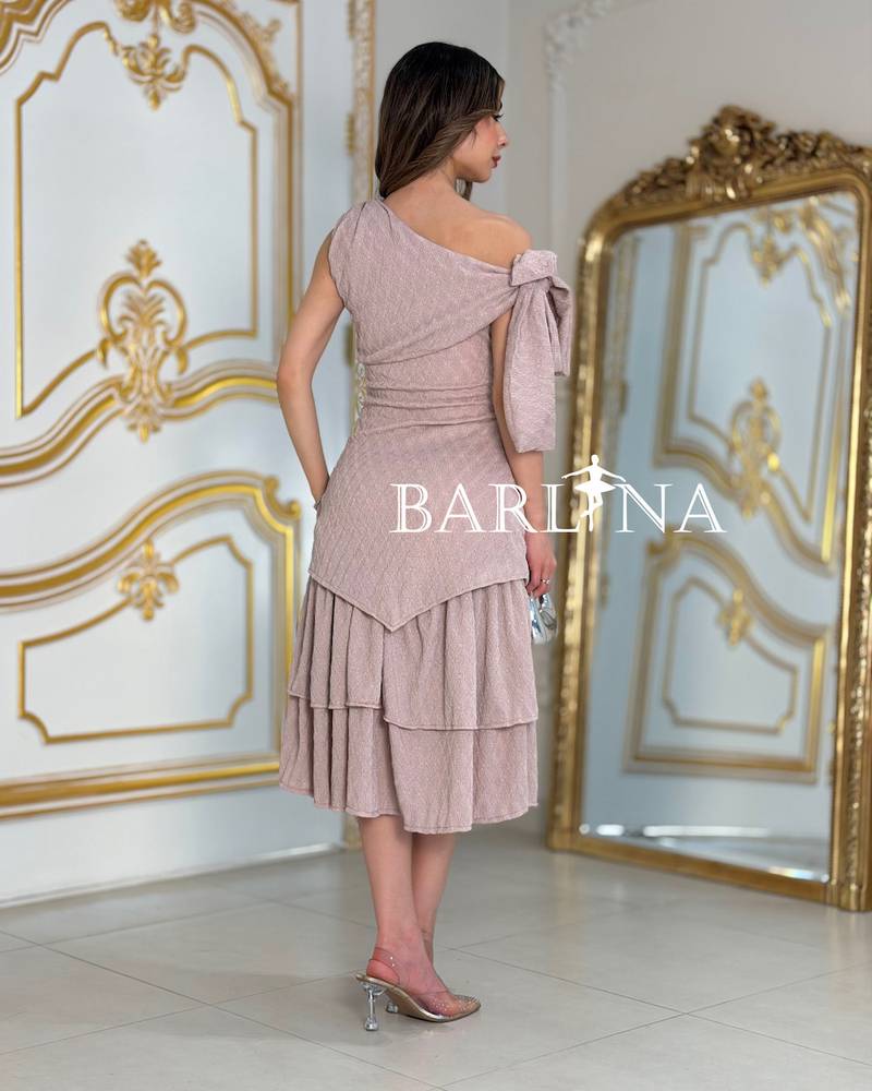 A soft dress with an elegant bow and layered details