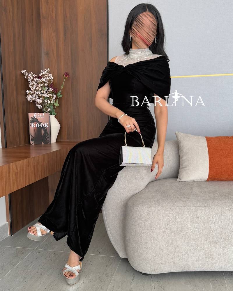 Black dress with high collar embroidered with sequins