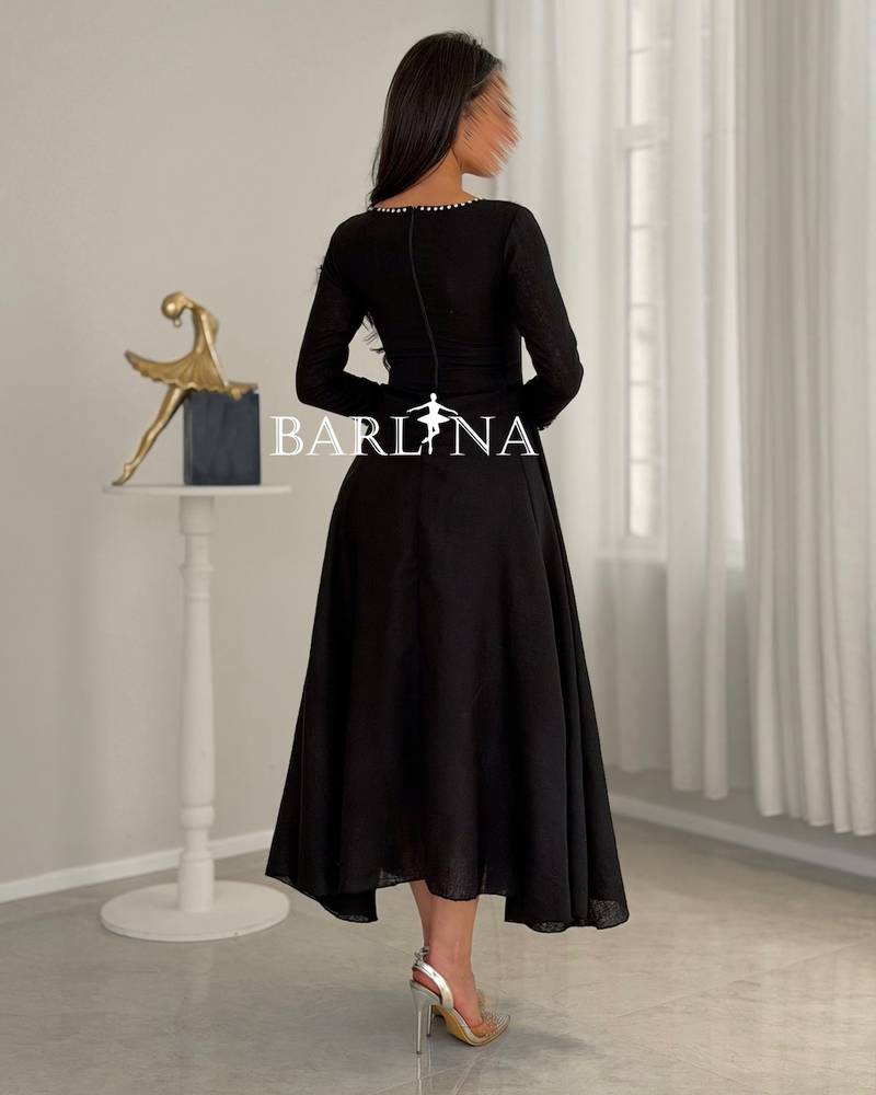 Black flared dress with pearl and crystal embellishments