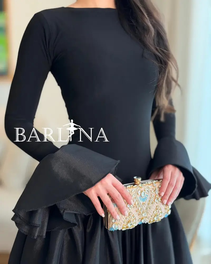 Elegant black dress with a high-cut top and long sleeves