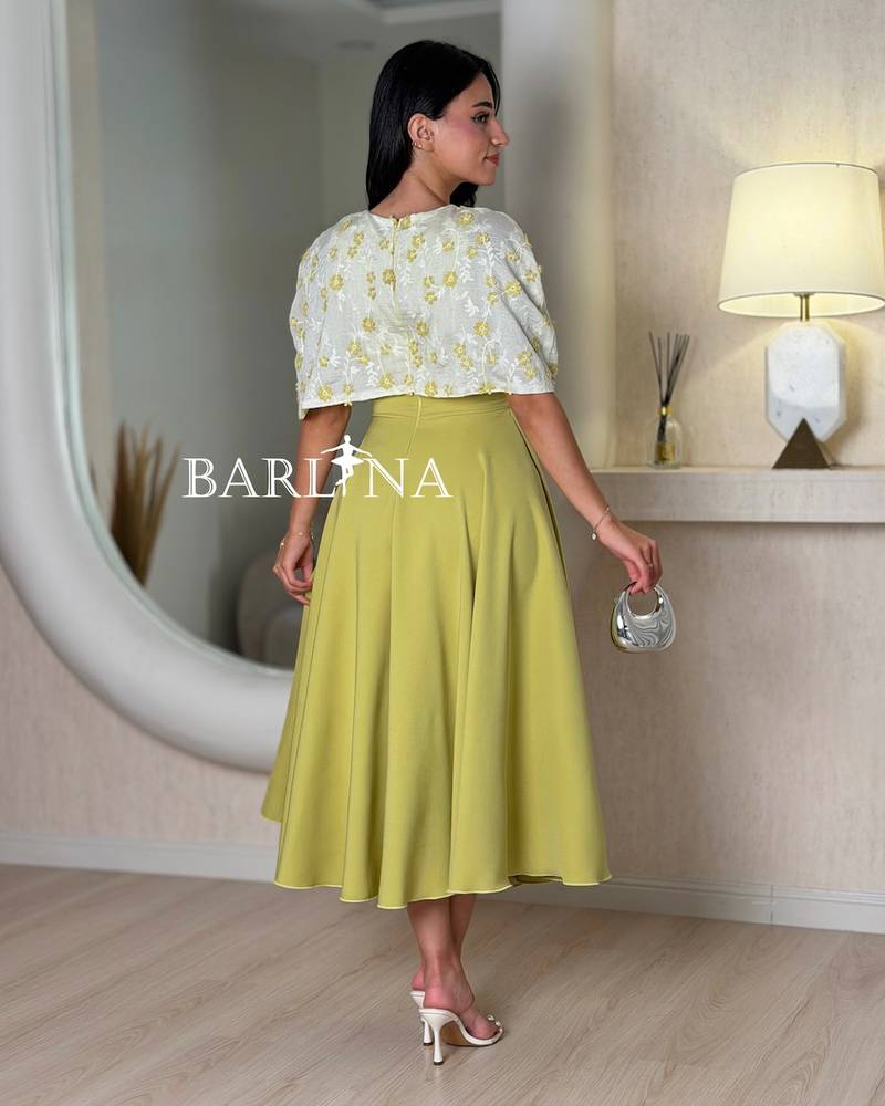 Elegant apple-colored dress with embroidered top