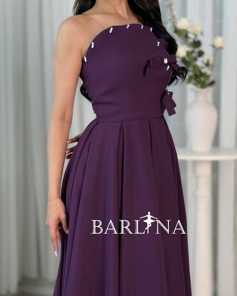 A purple dress with a simple cut and side details.