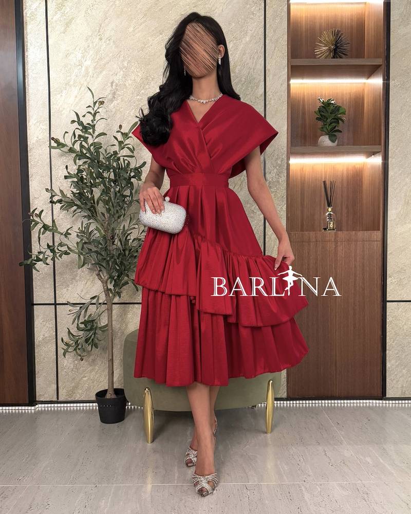 Elegant red layered dress with broad shoulders