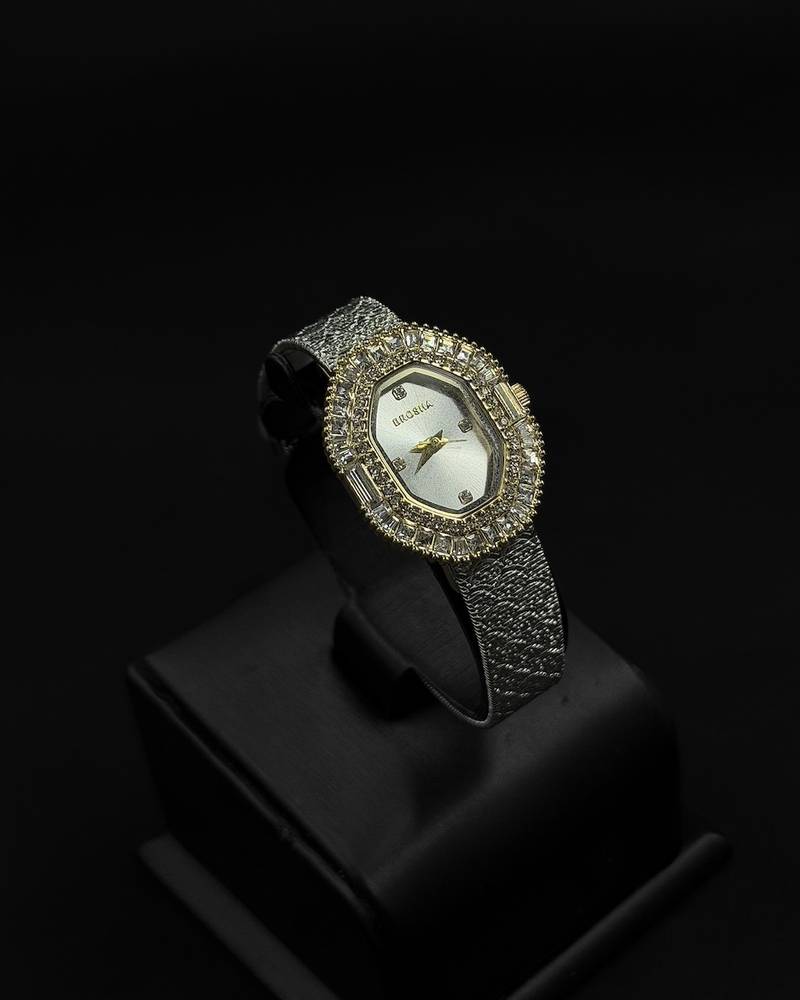 Womens watch with an oval bezel fully studded