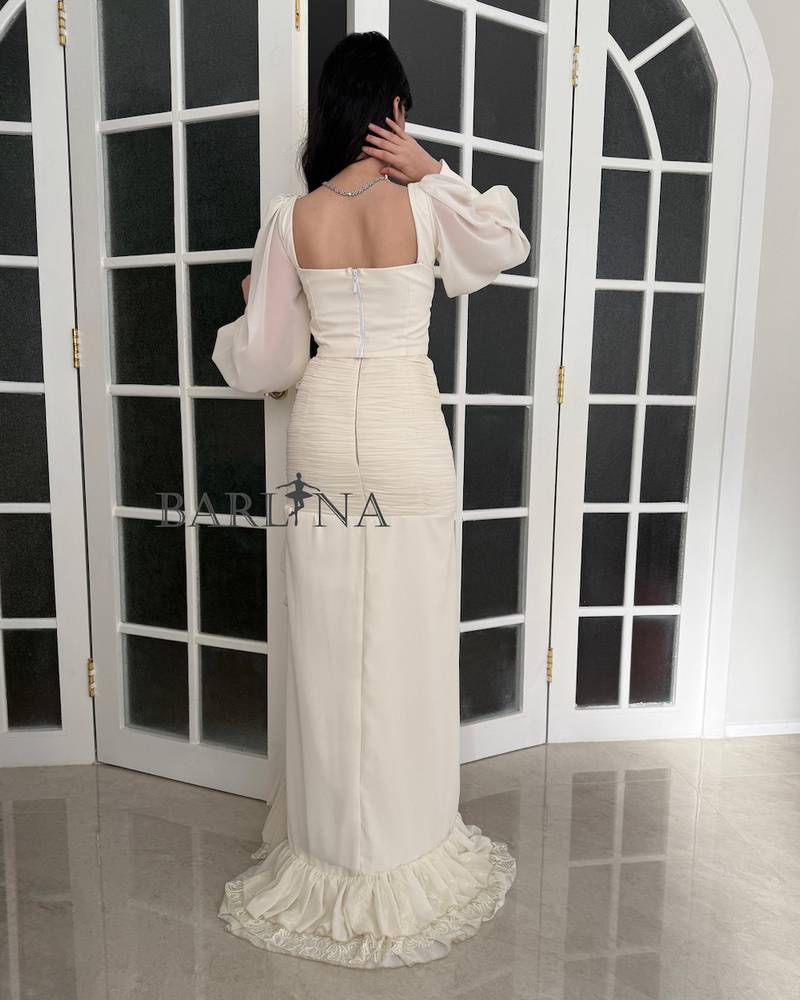 Off-white dress with a soft corset and luxurious side ruffles