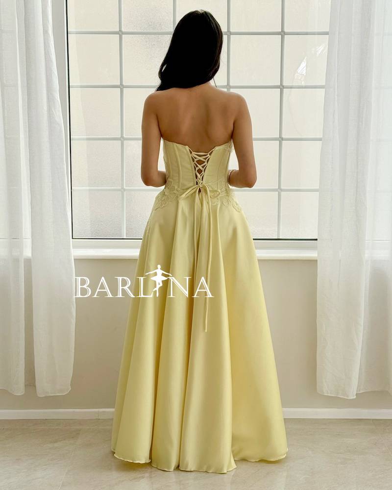 Light yellow evening dress with an embroidered corset cut