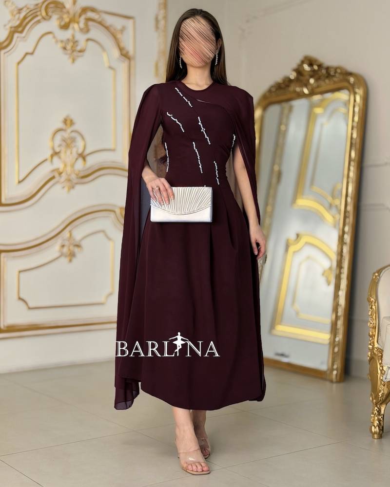 Burgundy dress with flowy shoulder cape