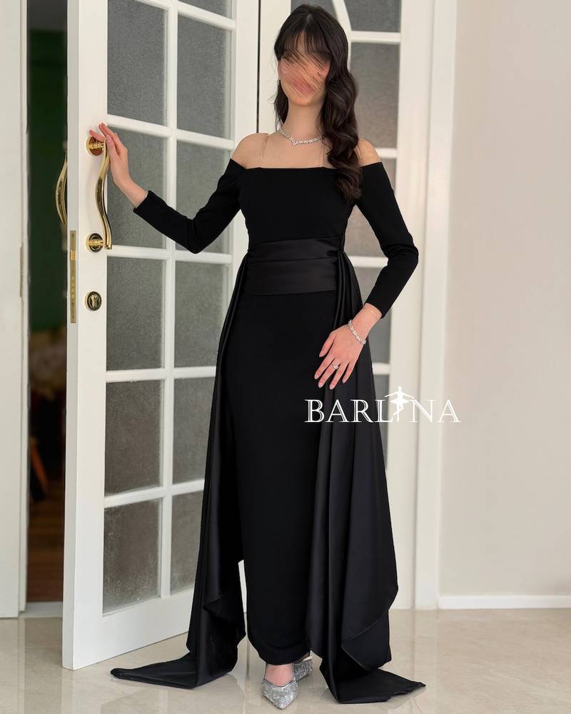 Black off-shoulder dress with a soft side train