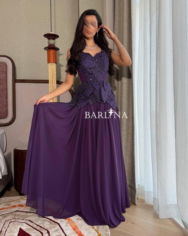 A flowing purple dress with delicate embroidery