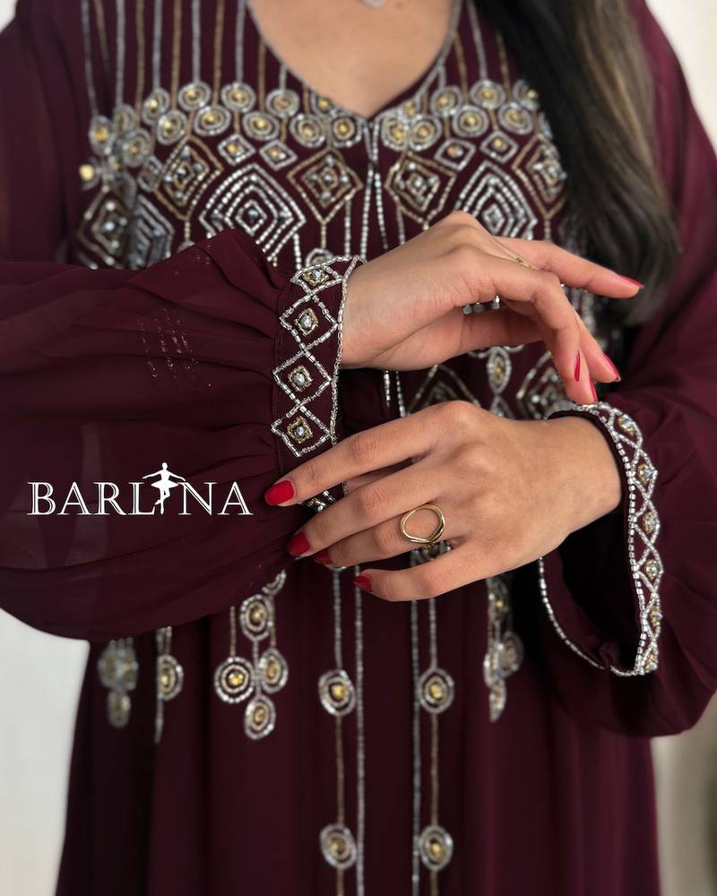 Burgundy jalabiya adorned with delicate embroidery on the chest