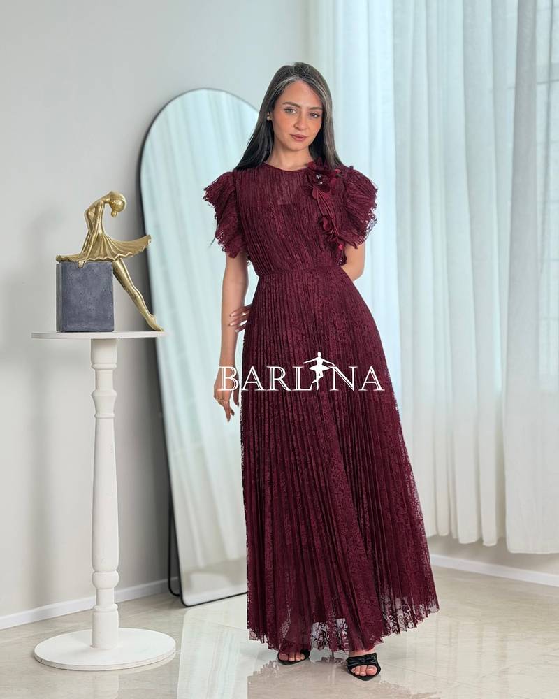 A burgundy dress made of lace fabric with ruffled sleeves