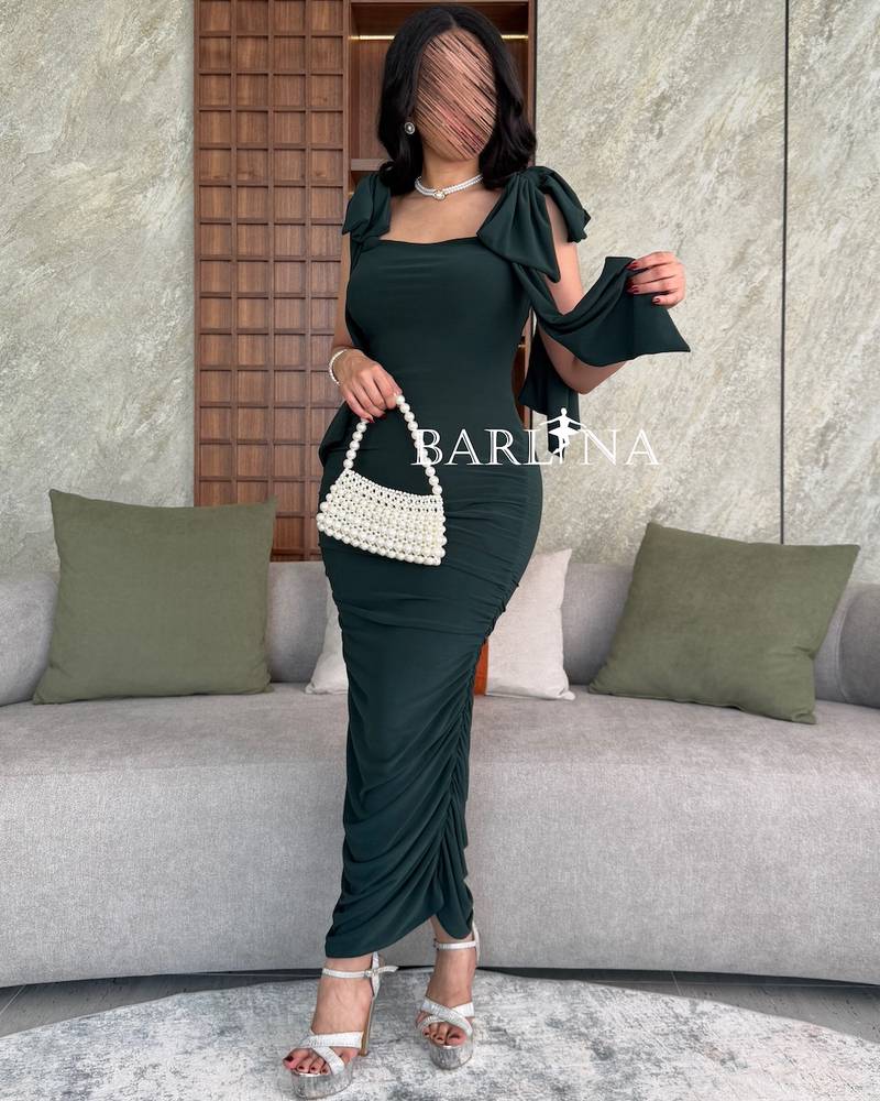 Dark green dress with bow on the shoulders