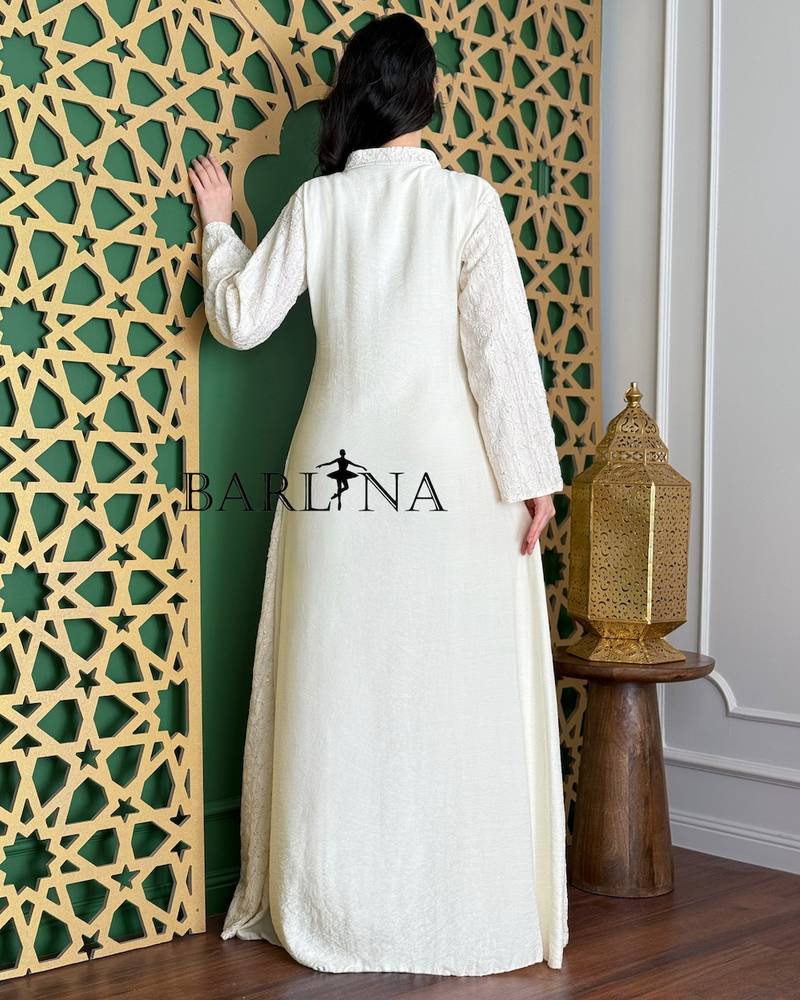 A white jalabiya with delicate embroidery and a straight cut.
