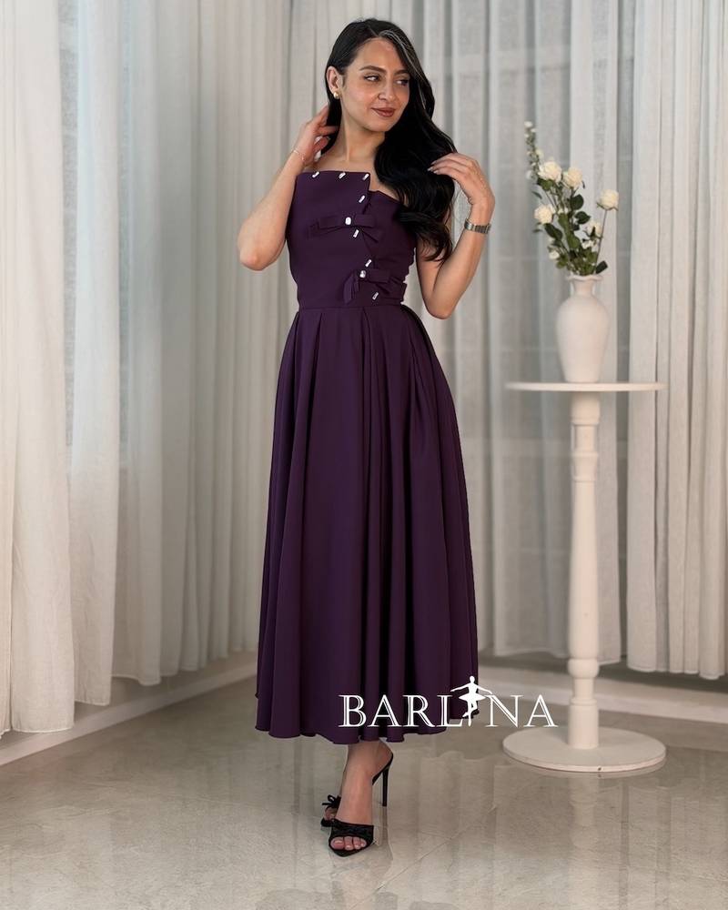 A purple dress with a simple cut and side details.