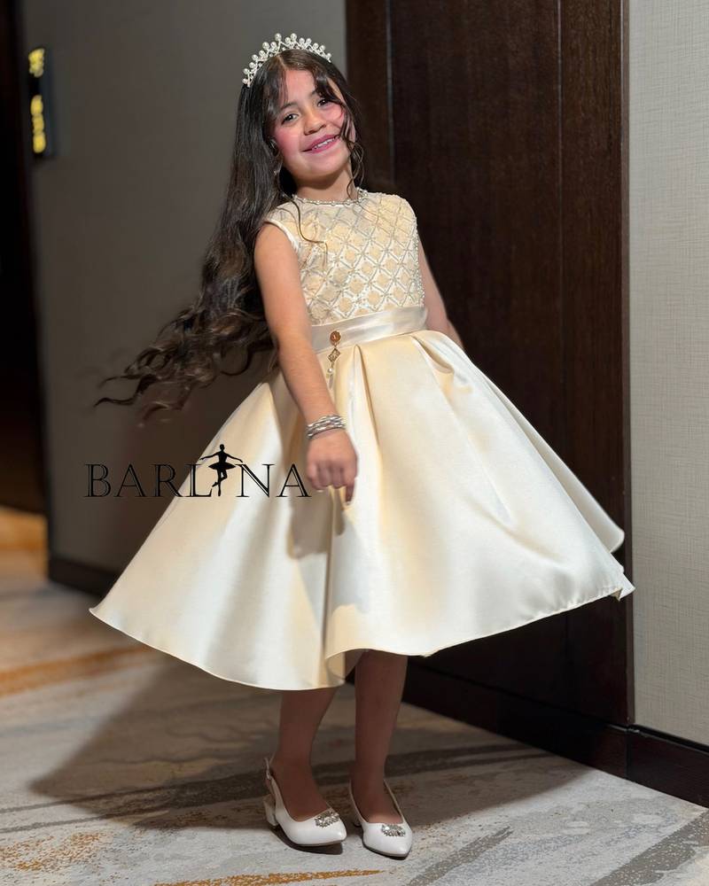Beige girls' dress with a gold embroidered bodice