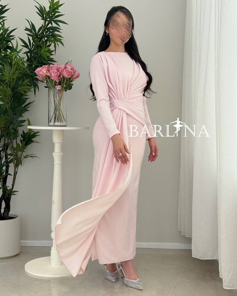 A soft pink dress with elegant details at the waist