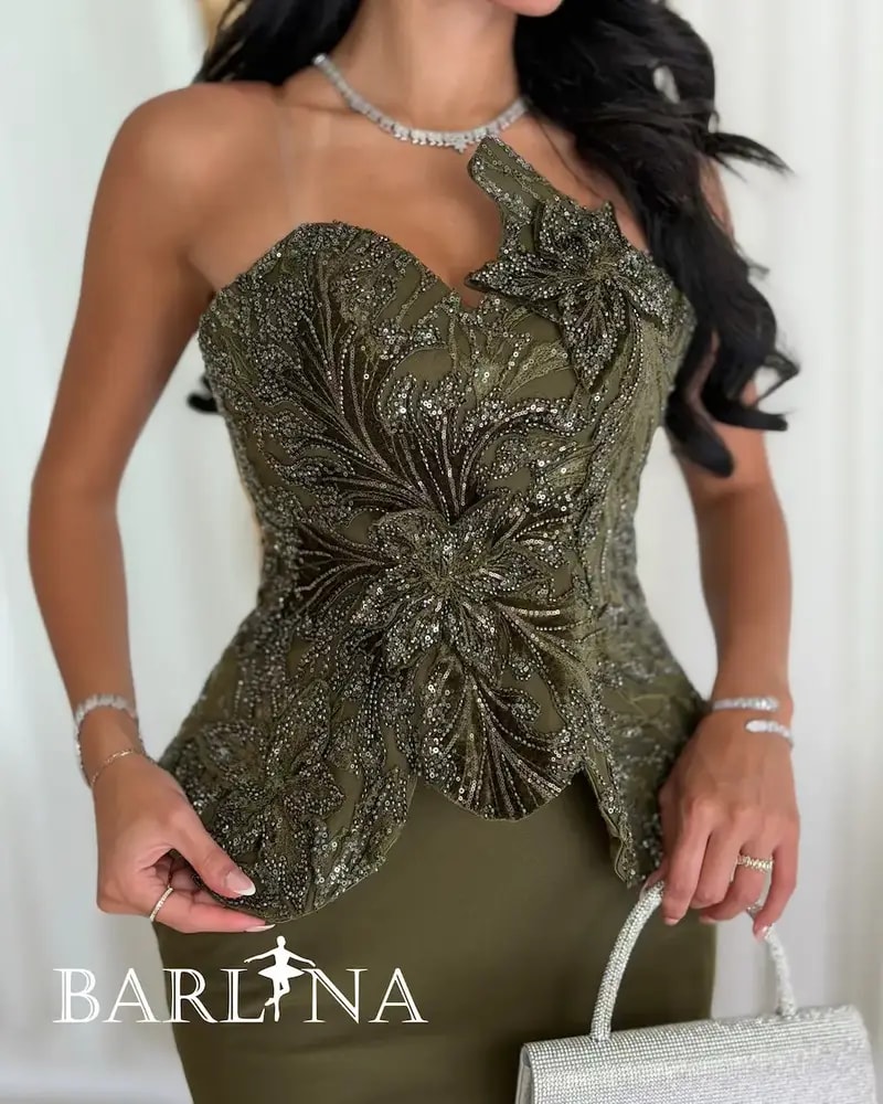 Olive green dress with prominent embroidery details