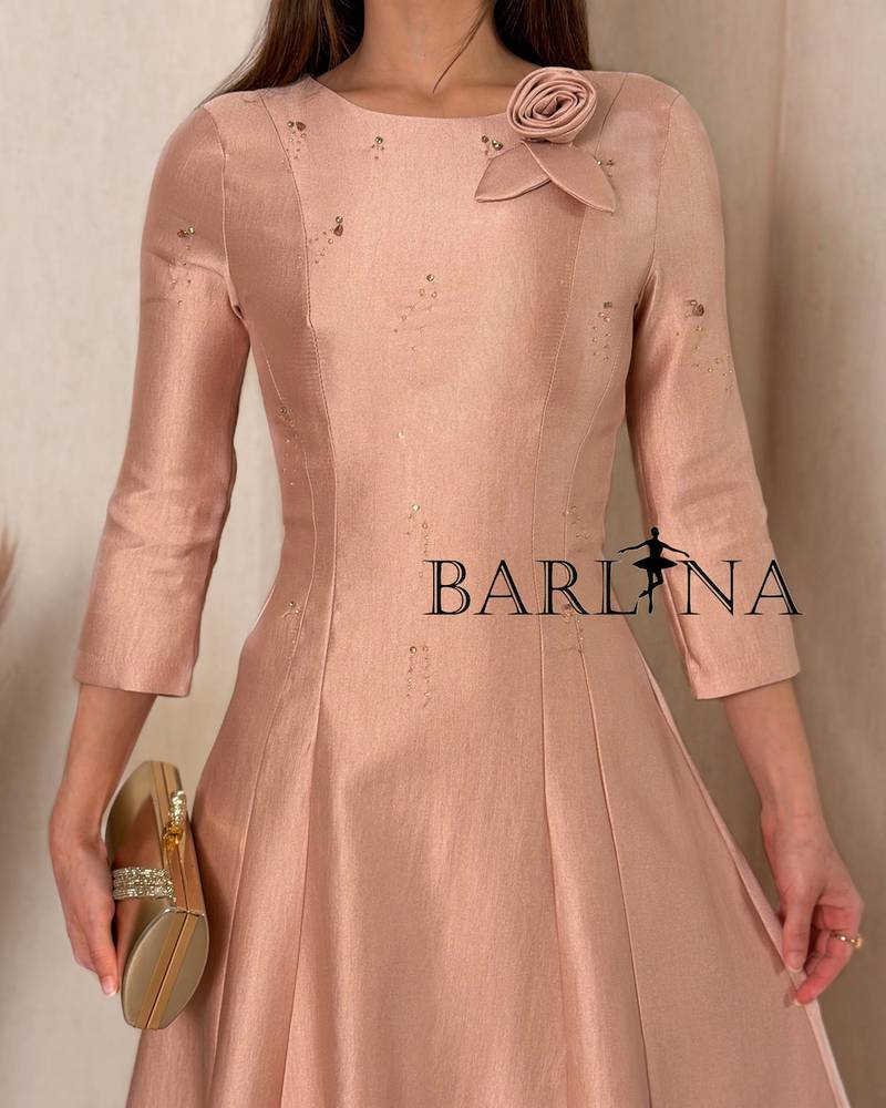 A soft midi dress adorned with a delicate rose