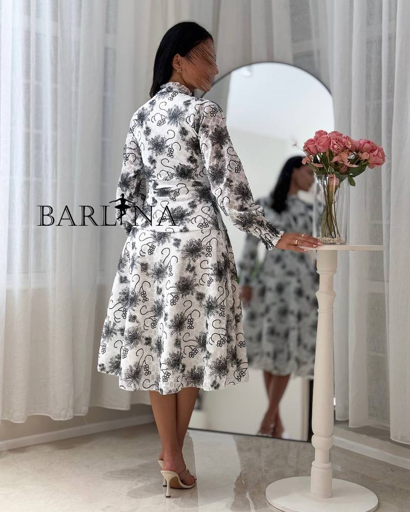 A soft white dress with black floral patterns