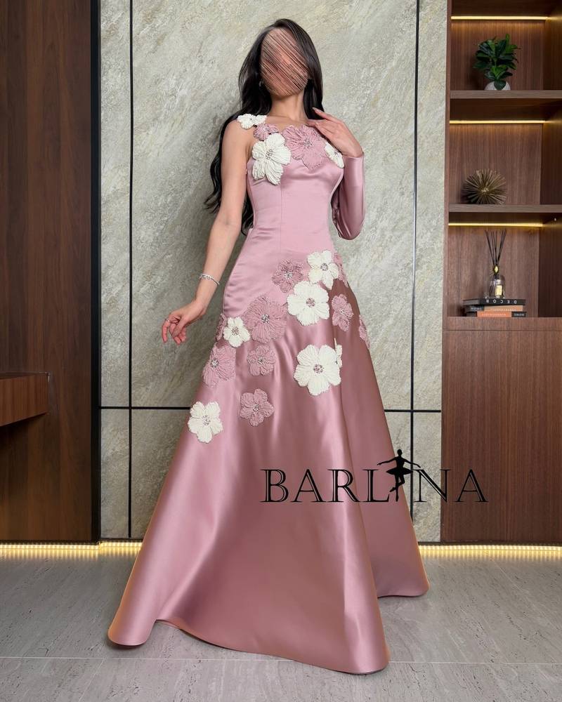 pink dress adorned with flowers and one long sleeve