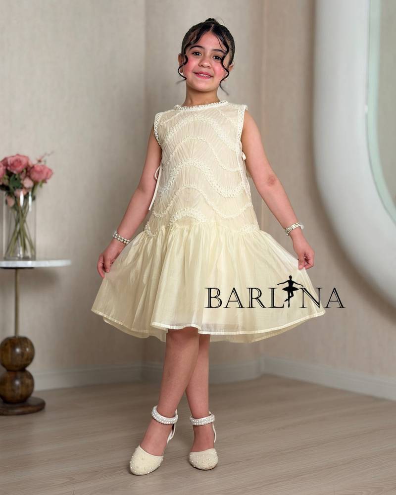 Girls dress in a soft cream color