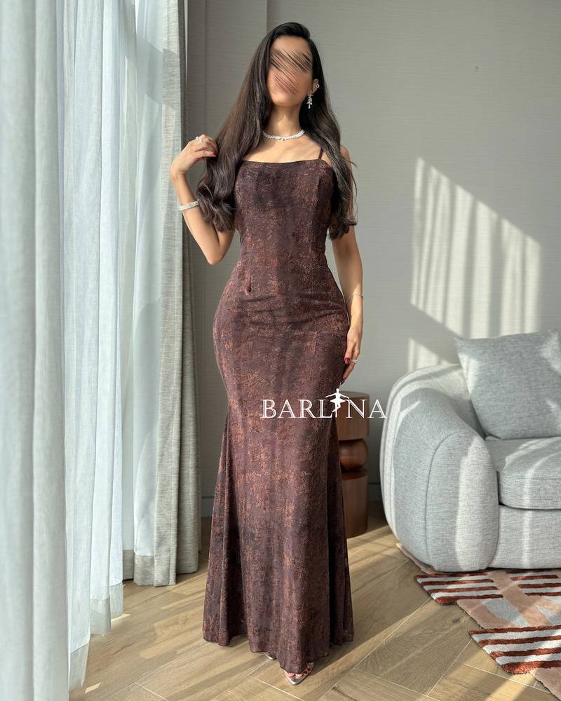 Long brown dress with shiny fabric and a fitted silhouette
