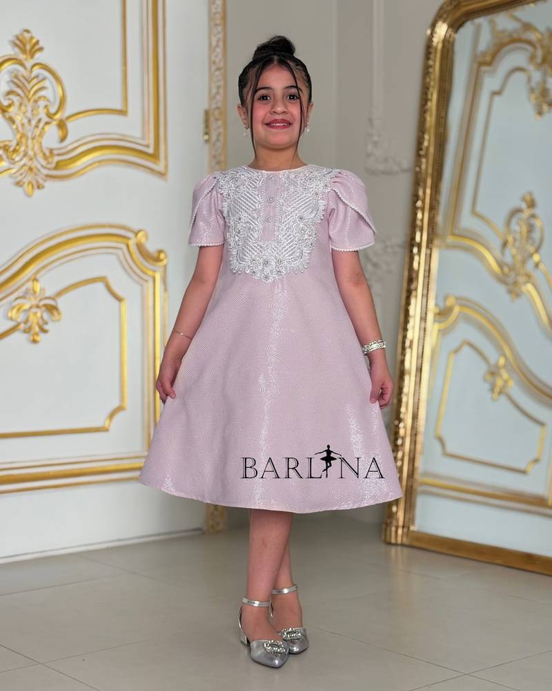 Light mauve girls' dress with white patterns on the chest