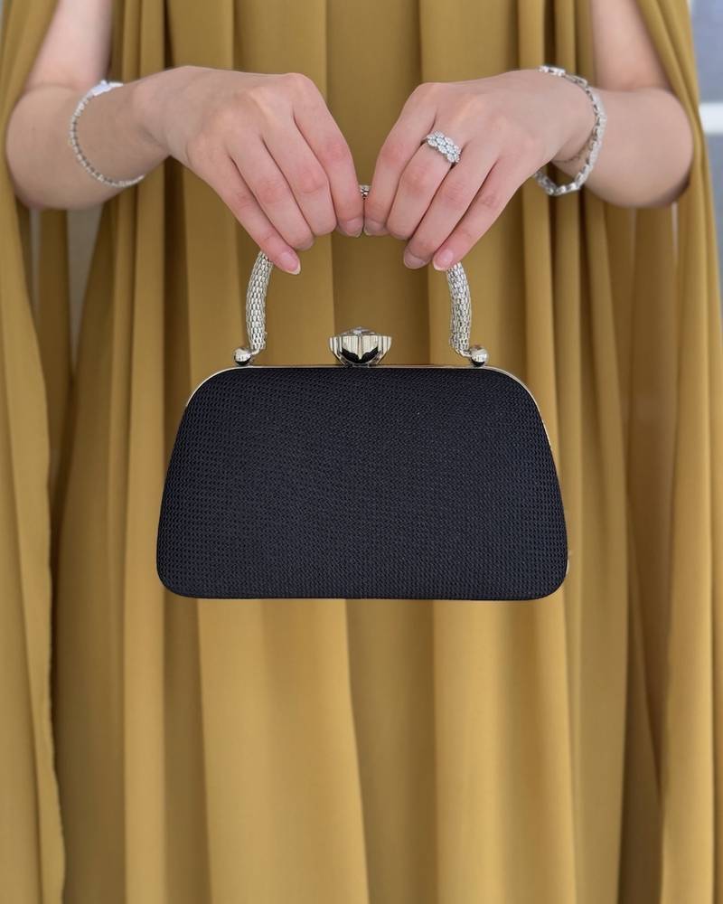 Gold evening bag with a metal frame and top lock