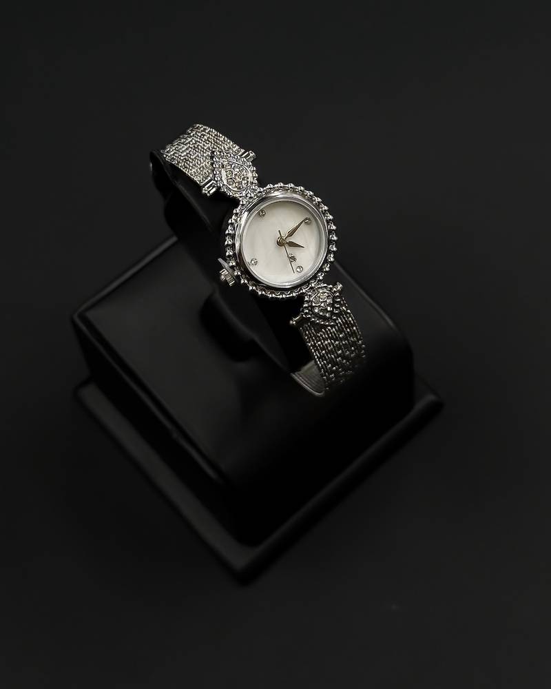 A delicately designed accessory set with a jeweled watch.