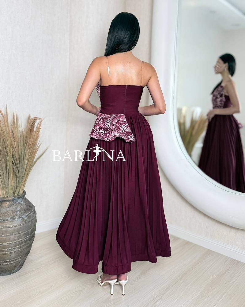 A soft burgundy dress with an elegant embroidered bodice