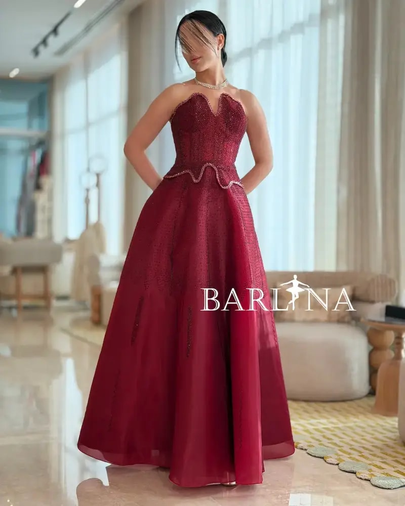 Burgundy puffy evening dress with a corset design