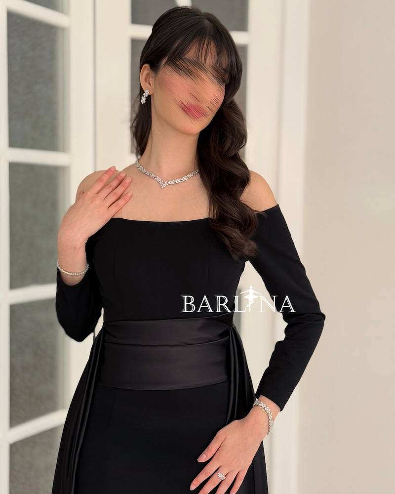 Black off-shoulder dress with a soft side train