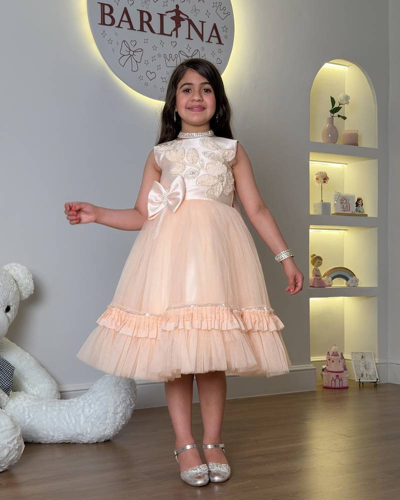Girls' peach tulle dress with a large bow