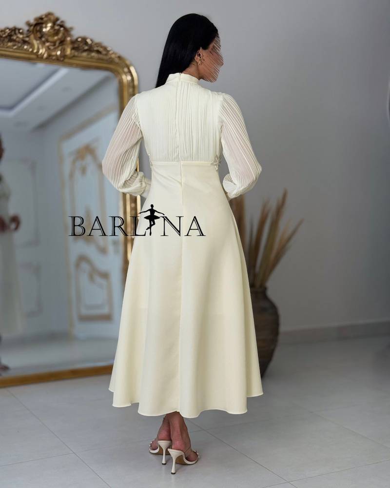 Beige dress with delicate details and sheer sleeves