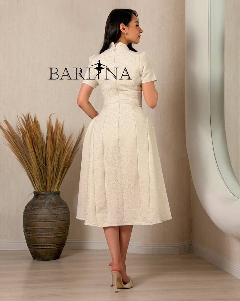 A classic off-white dress with delicate patterns