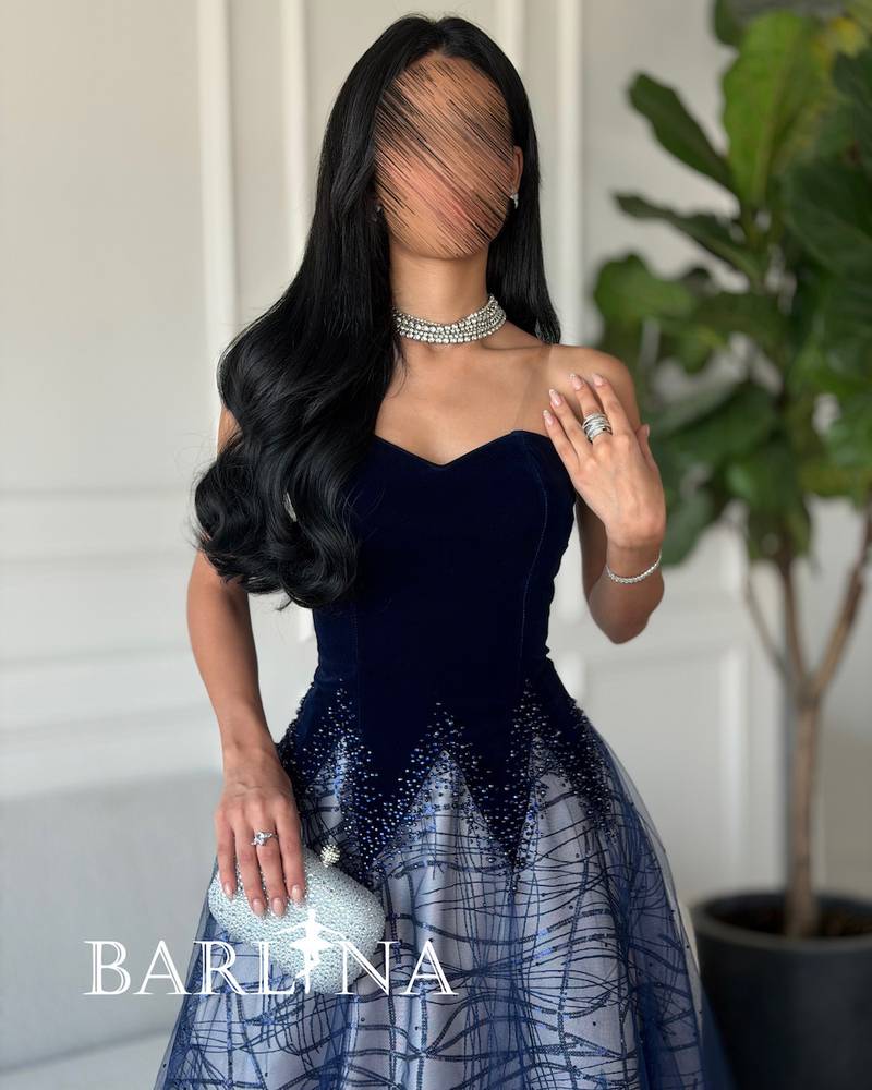 A woven dress with embroidery and shimmering gradients