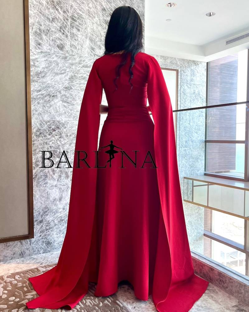 Long red dress with twisted design and cape sleeves