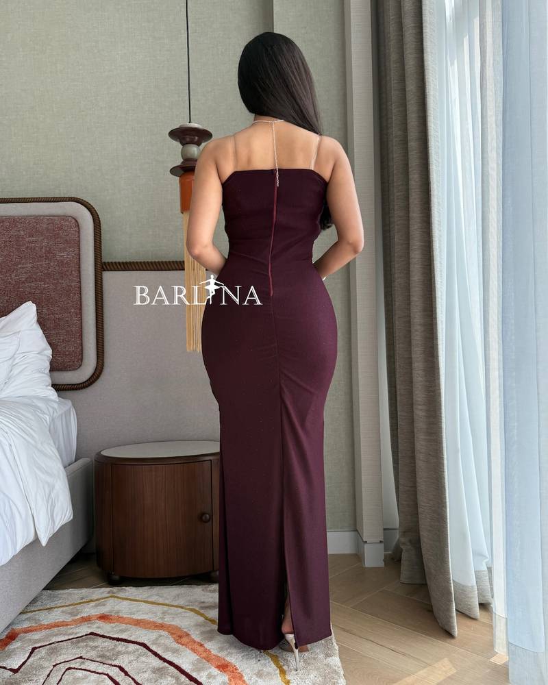 A fitted burgundy dress with gathered details