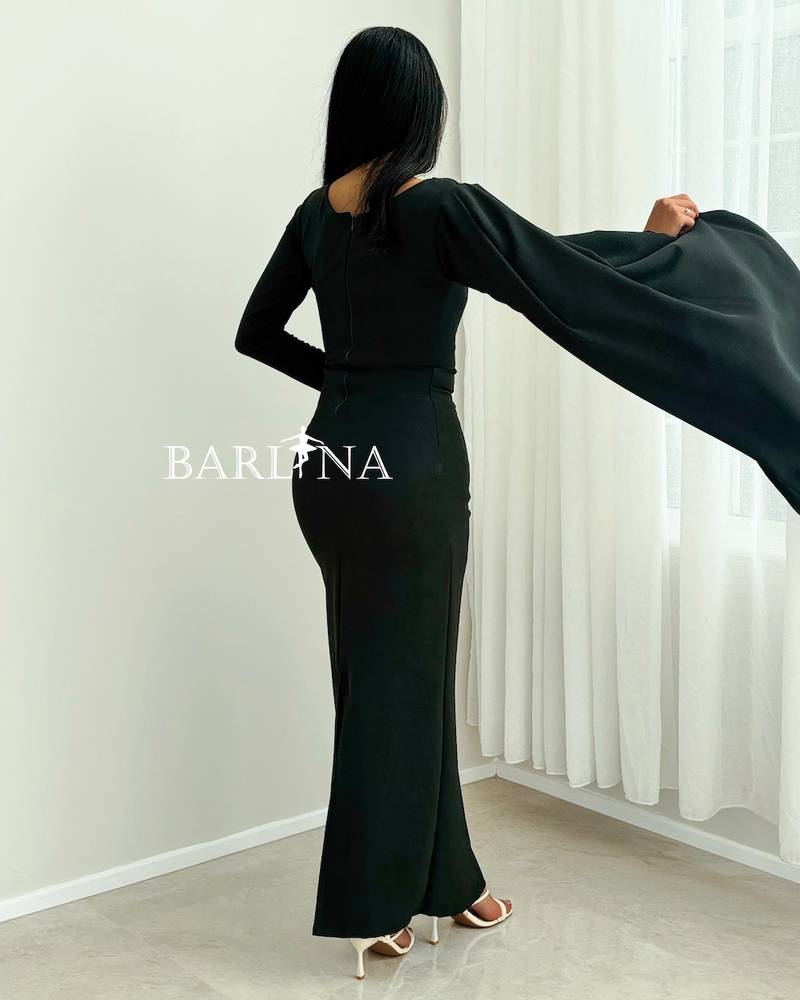 An olive-green dress with a draped cape over the shoulder